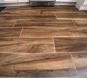 Closeup of medium dark hardwood floor installed as part of a contemporary kitchen remodel in Los Angeles