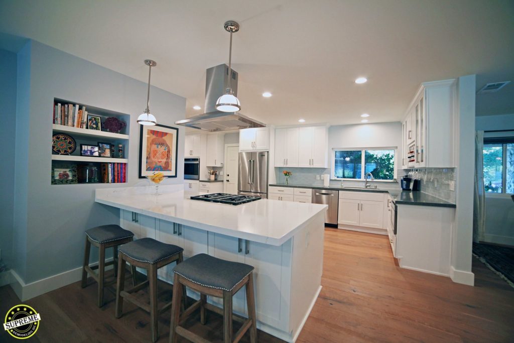 Woodland Hills kitchen featuring a peninsula, LED recessed lighting, pendant lighting, and shake style cabinetry.