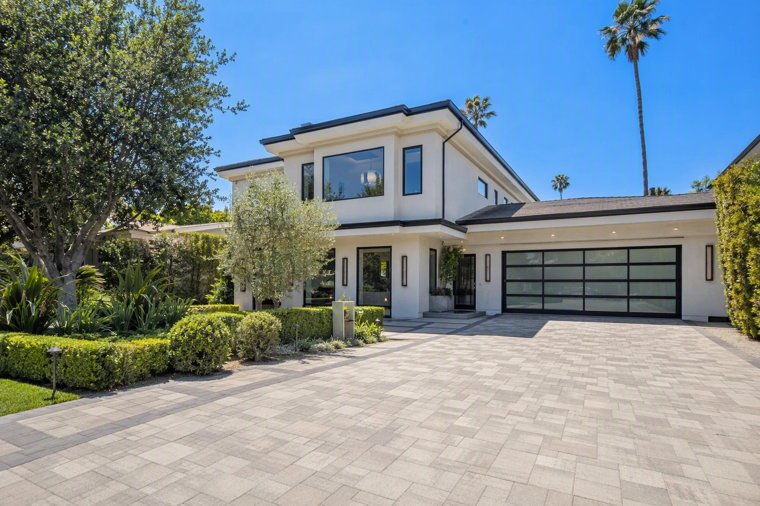 Completed modern home remodel exterior in Los Angeles with new pavers and landscaping