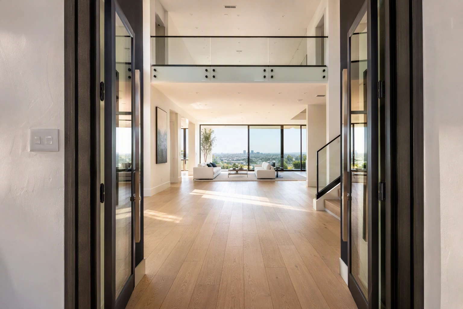 Bright open-concept living room seen from the entry foyer of a remodeled home